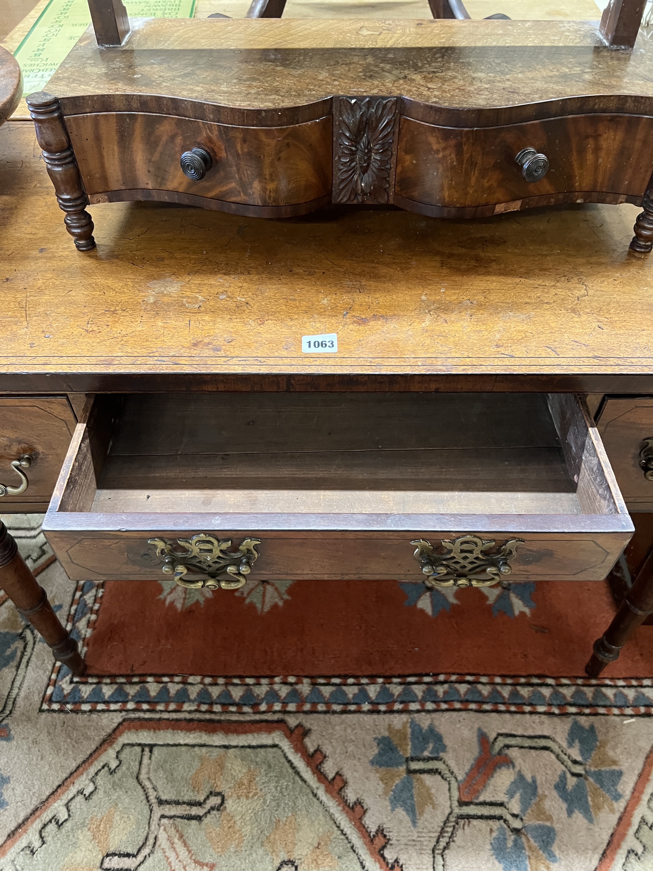 A Regency mahogany kneehole dressing table, width 94cm, depth 50cm, height 72cm together with an early Victorian mahogany serpentine front toilet mirror
